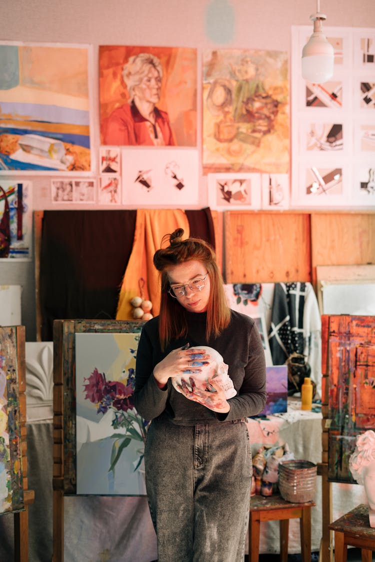 A Woman Holding A Skull Sculpture