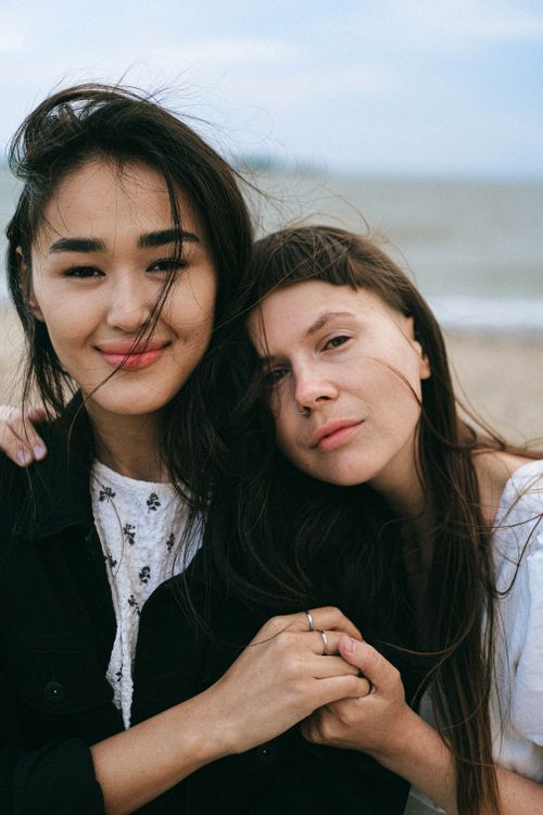 Free Close-up portrait of a couple embracing by the beach, capturing love and connection. Stock Photo