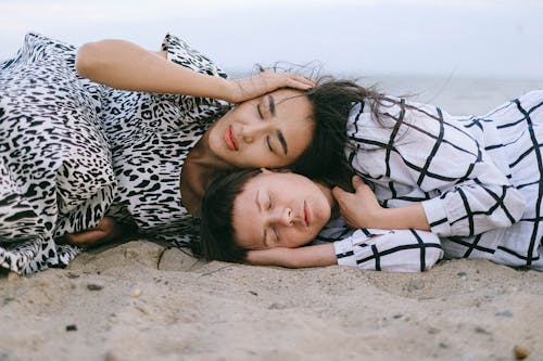 Women Lying on Beach Sand