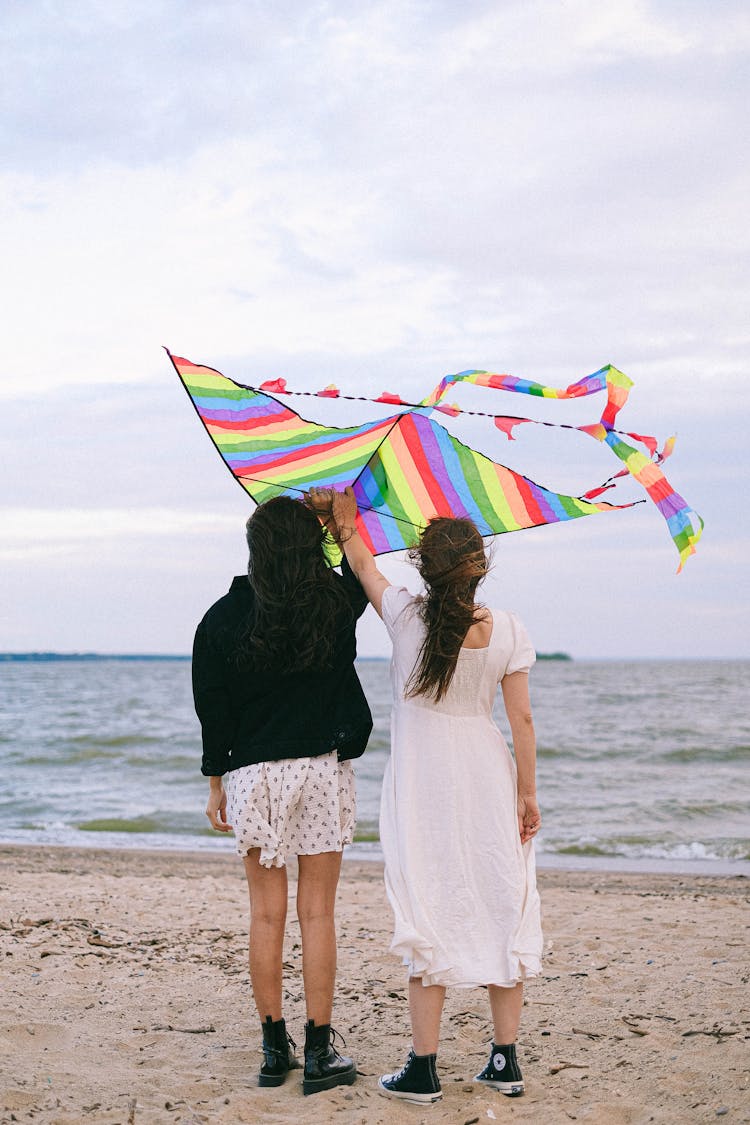 A Couple Holding A Rainbow Kite