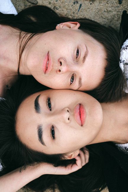 Close-up of a same-sex couple lying together, showcasing love and connection.