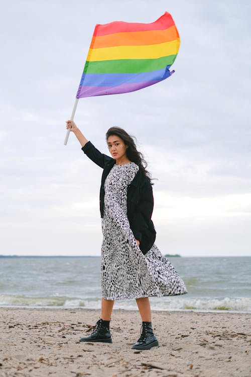 Woman Raising Rainbow  Flag