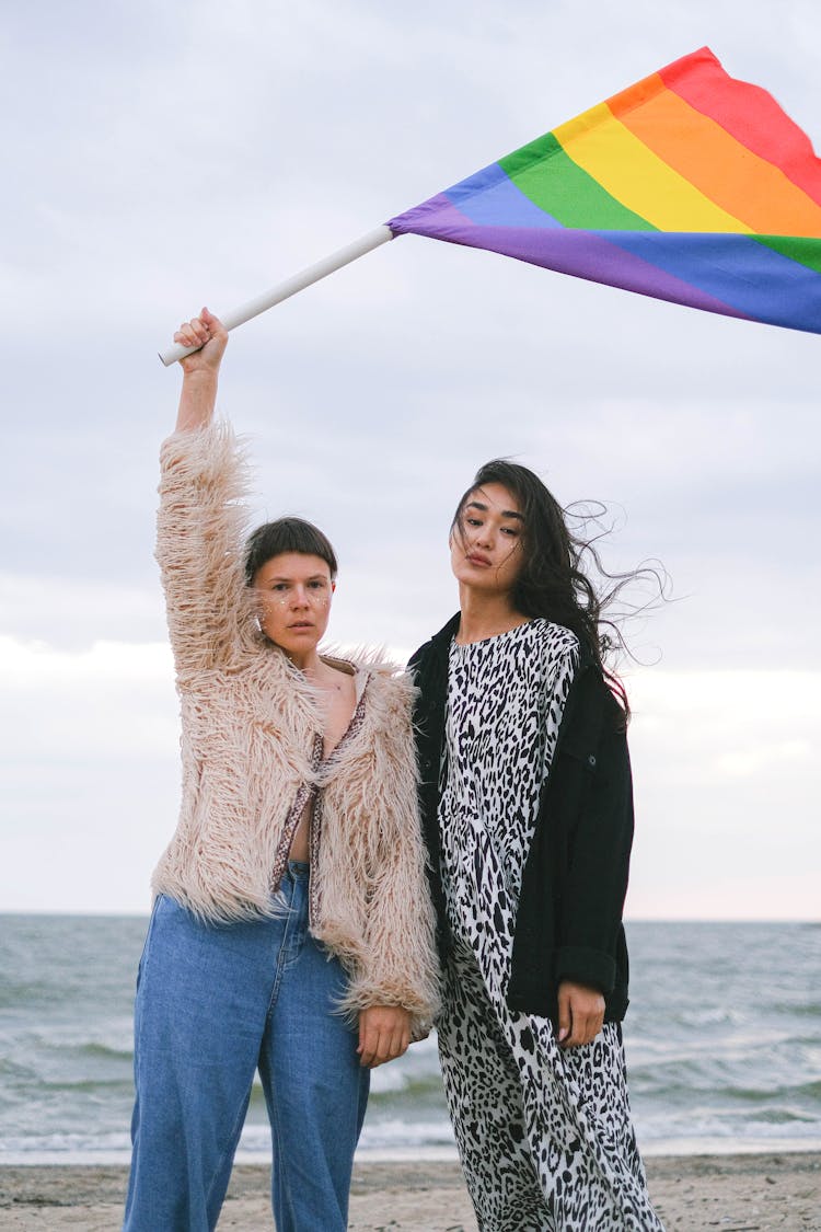 A Woman Waving A Rainbow Flag