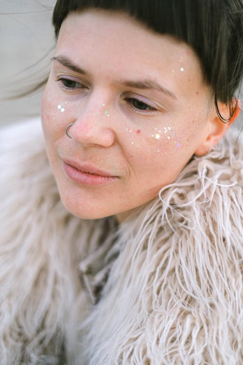 Woman with spangles and piercing in nose