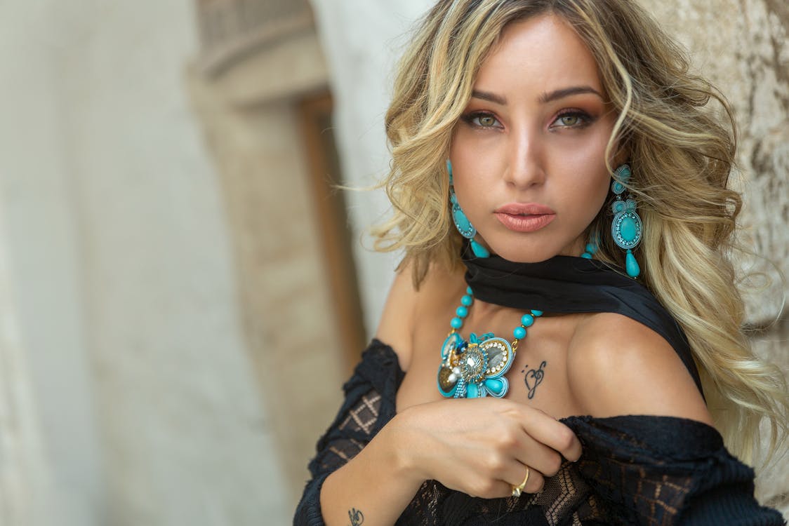 A Beautiful Woman Wearing Blue Earrings and Necklace