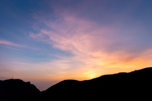 Free A breathtaking sunset with vibrant colors over the mountains of Ras al Khaimah, UAE. Stock Photo