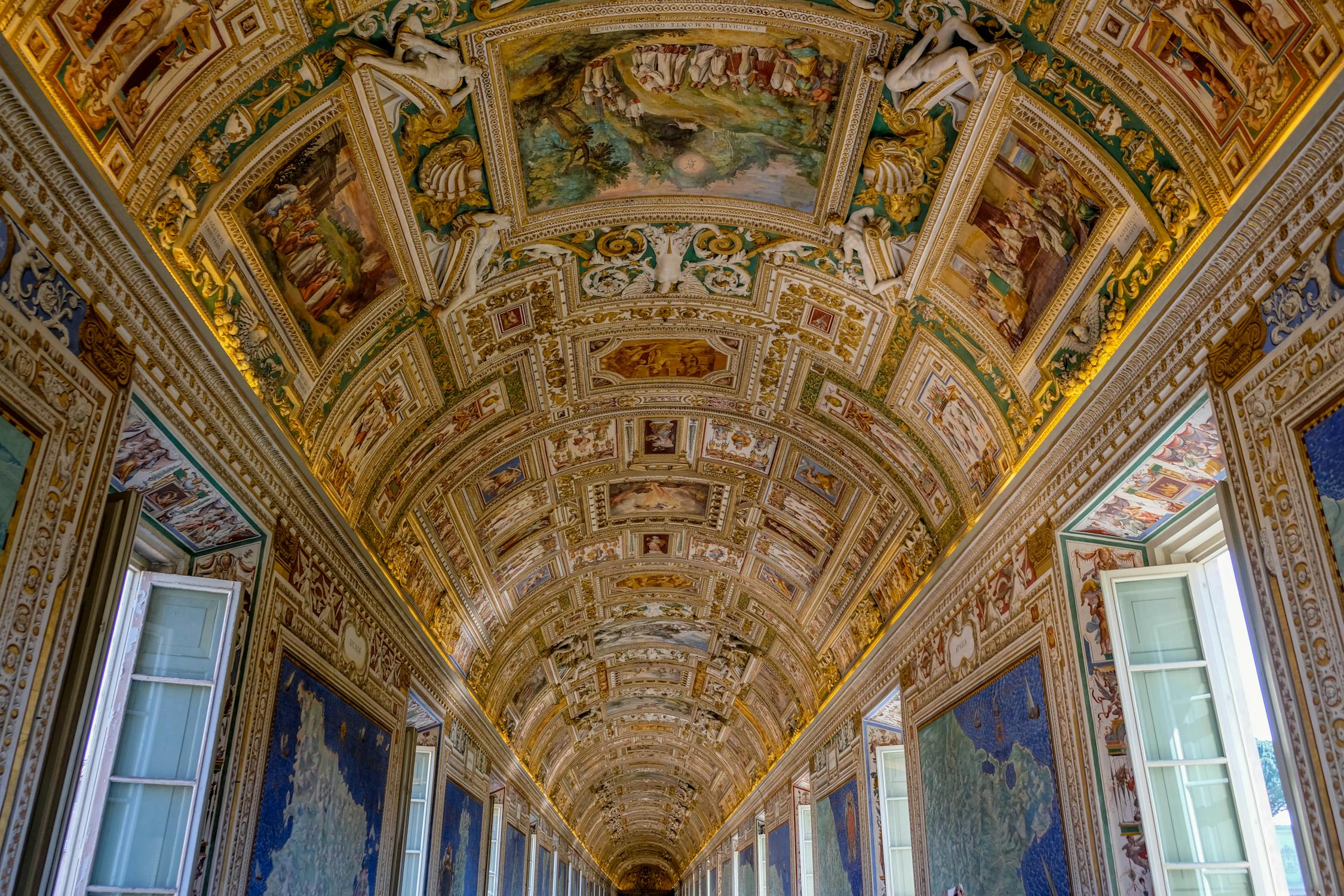 The painted ceiling of Vatican Museum, one of the popular historical sites in Rome