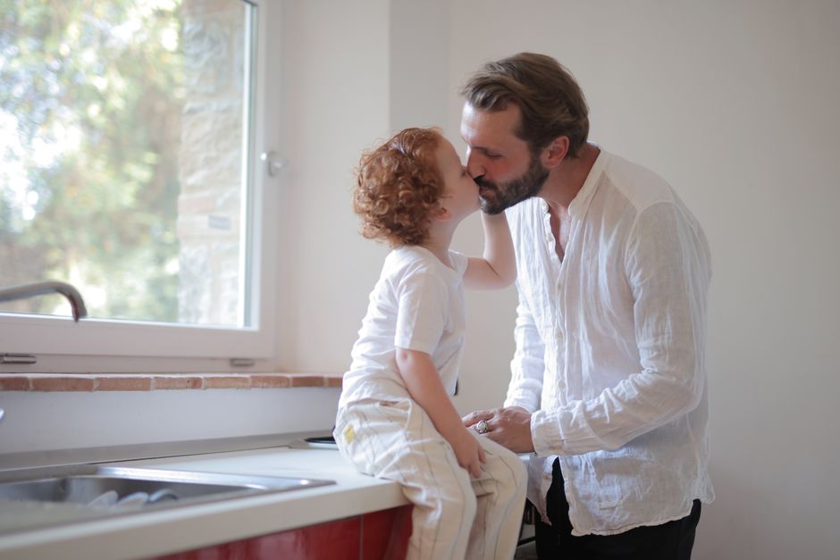 Photo by Andrea Piacquadio on Pexels A heartwarming scene of a father and son sharing a kiss in a sunlit kitchen. - Photo by Andrea Piacquadio on Pexels