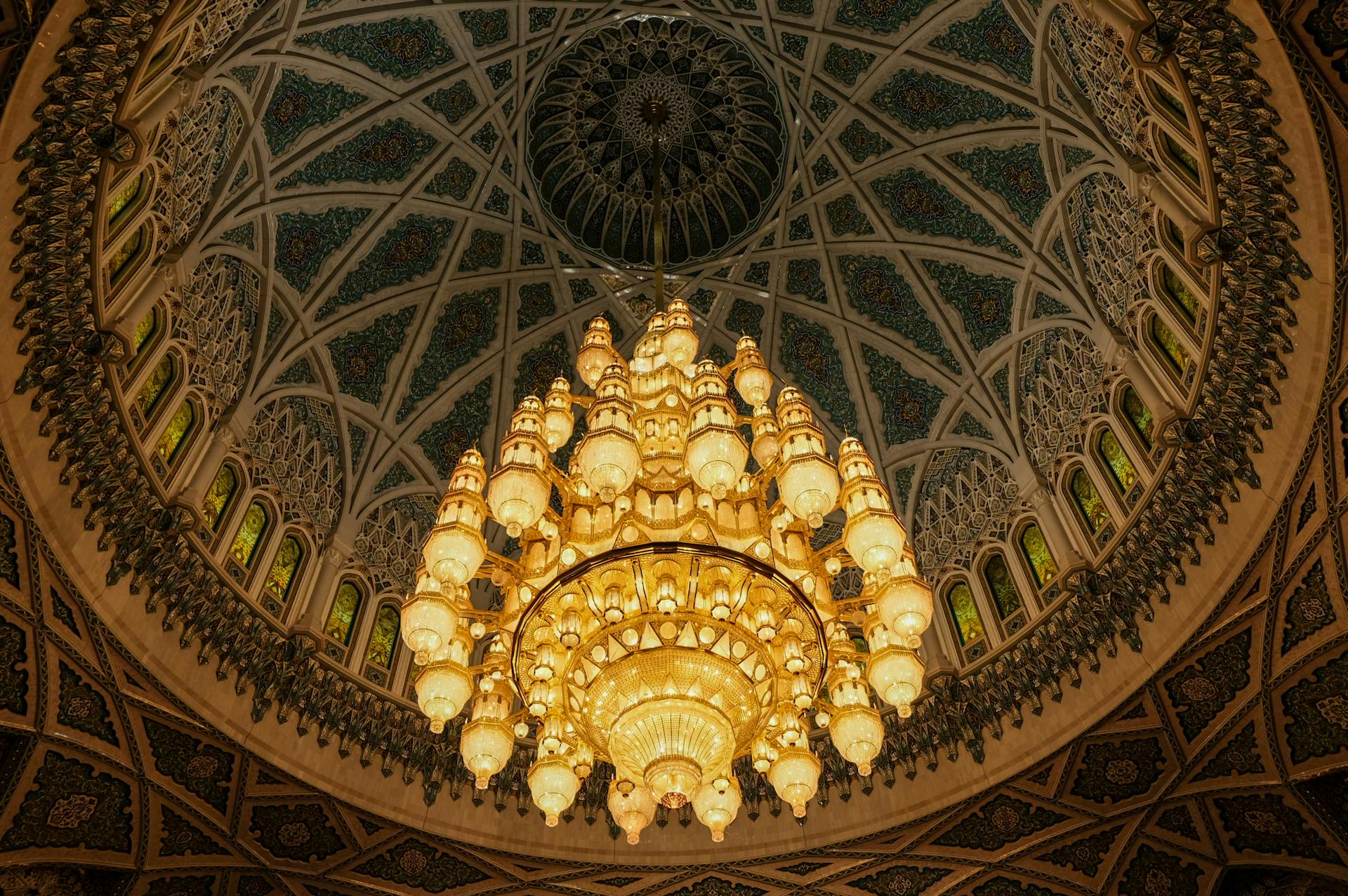 Stunning ornate mosque dome featuring an exquisite central chandelier.