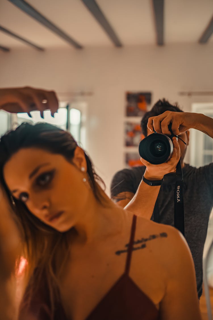 Man With Woman Making Selfie In Mirror