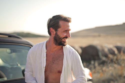 Smiling Man With Unbuttoned Long Sleeves