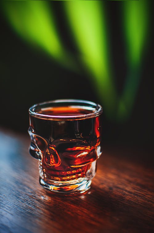Free Clear Shot Glass With Brown Liquid Stock Photo
