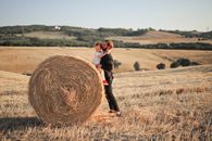 Woman in Black Jacket Standing on Brown Grass Field