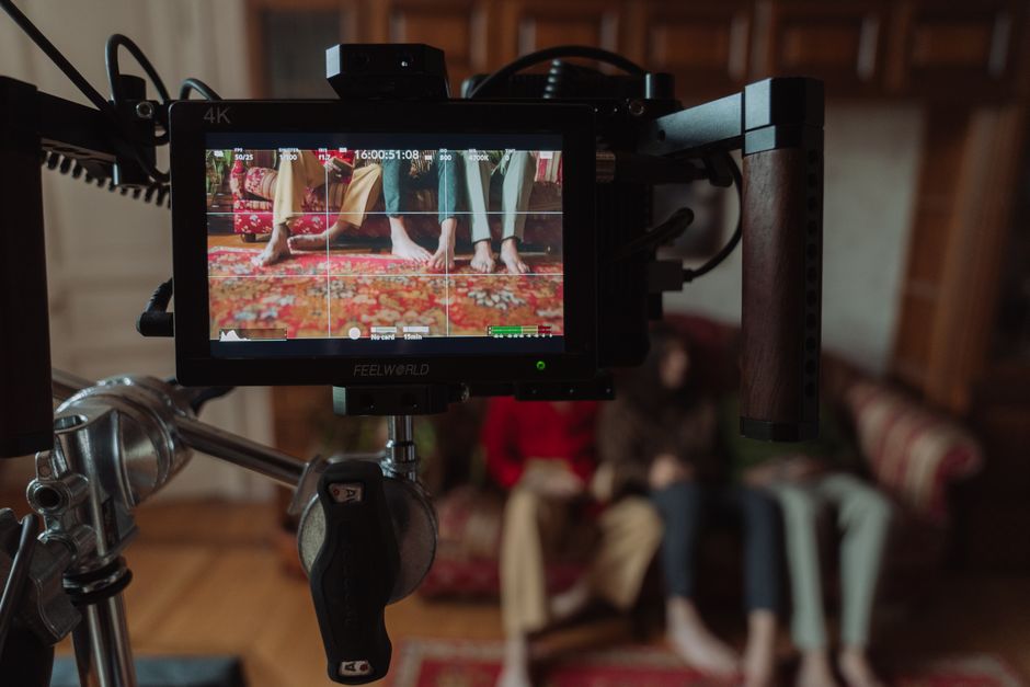 Wellness CORE vs Taste of the Wild: High Protein Dog Food Showdown for Active Breeds Film set monitor showing a scene with barefoot people sitting on a couch captured during production.