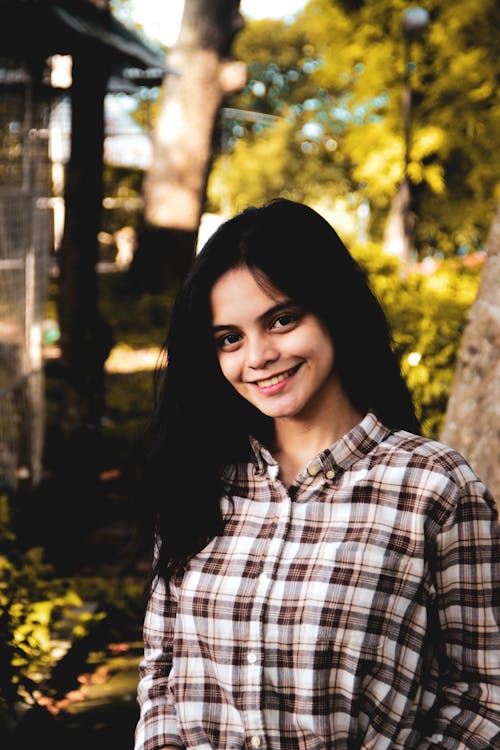 Woman in White and Brown Plaid Long Sleeves Smiling