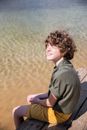 Woman in Gray Polo Shirt Sitting on Brown Sand
