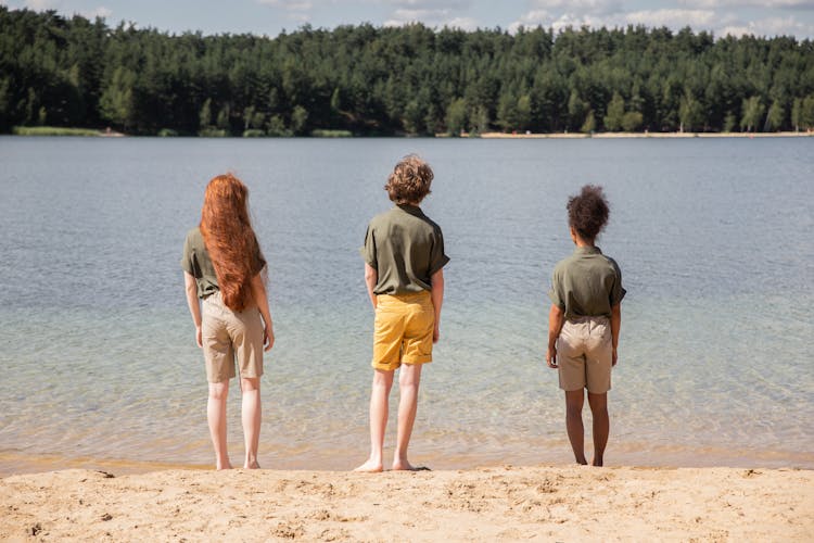 Children Standing Near Beach