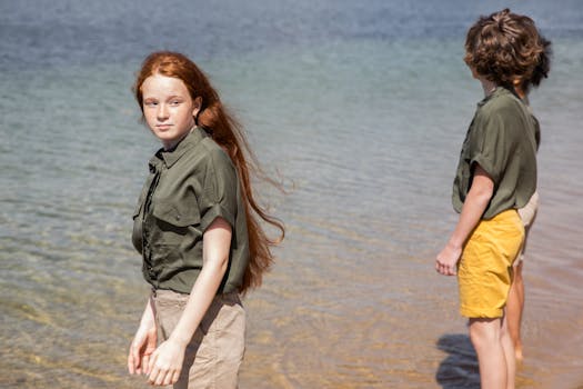 Teenagers enjoy a day by the sea in scout uniforms during summer.