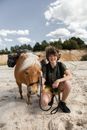 Portrait of a Boy with a Mule on Sandy Terrain
