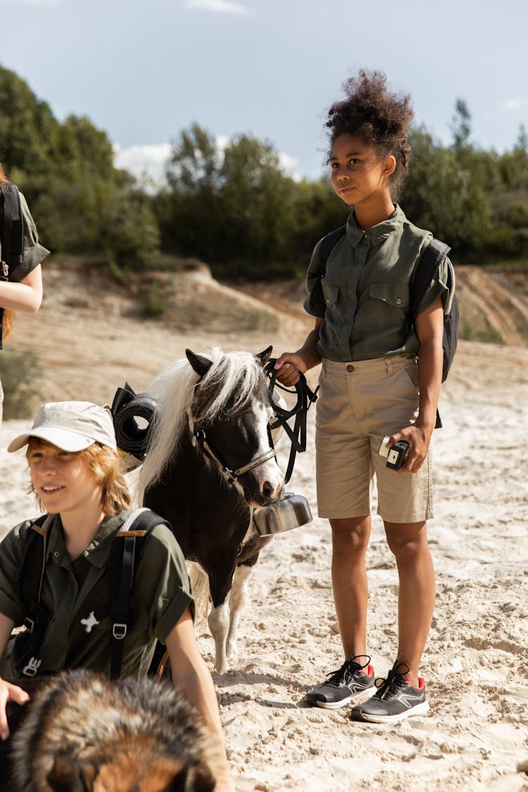 Teenagers Looking After Horse