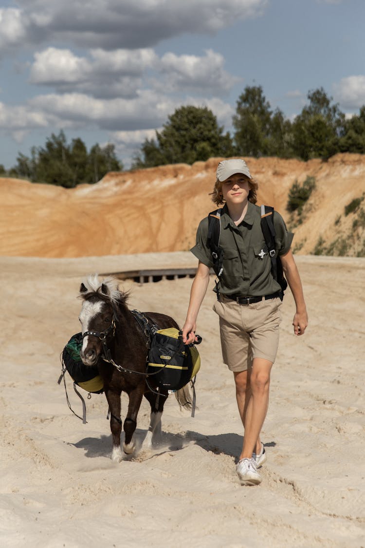 Boy Walking Donkey On Beach