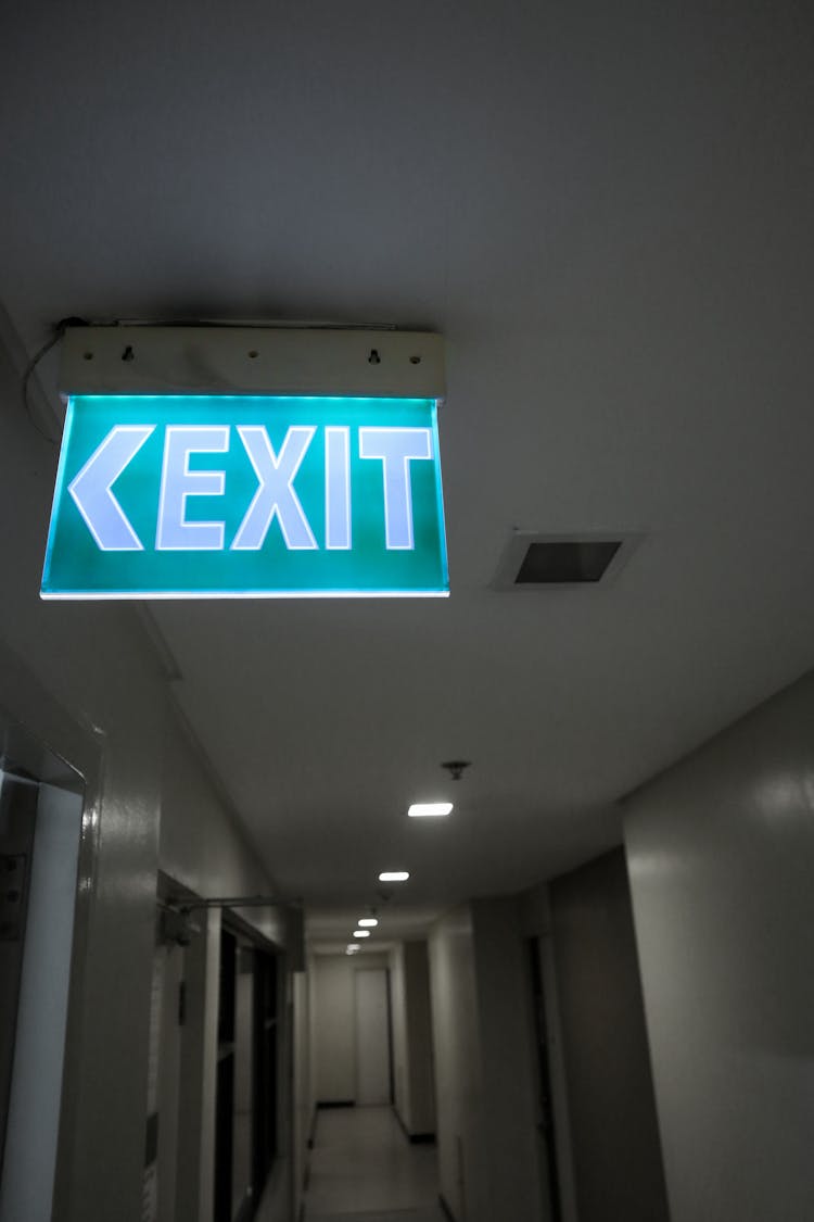 Lit Up Exit Sign In A Hallway