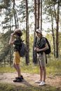 Man in Black Jacket and Brown Shorts Carrying Black Backpack