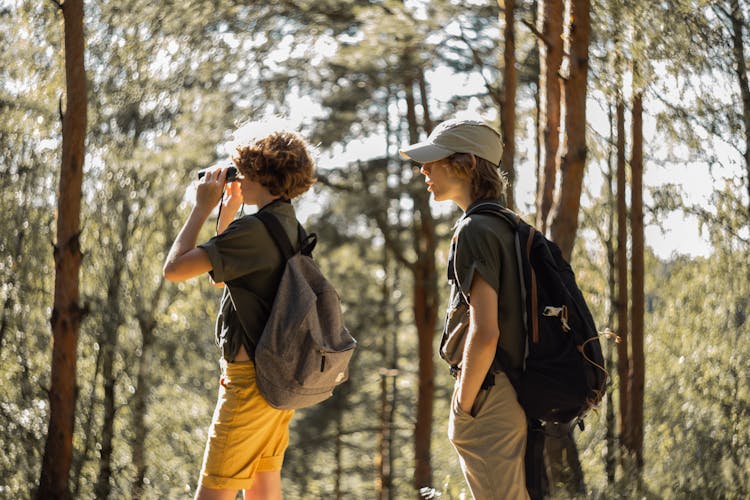 Couple Sightseeing Through Binoculars On Hike