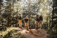 People Standing on Brown Rock Formation