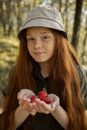 Girl in the Forest Holding Strawberries in Her Hands