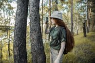 Girl Scout with Magnifying Glass Looking at Tree Trunk