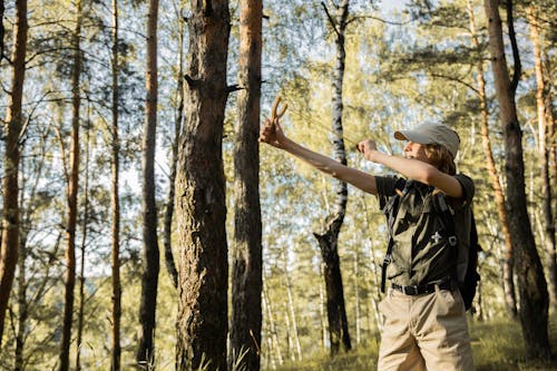 Young Scout Shooting with a Slingshot in a Forest