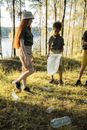 Man and Woman Walking on Green Grass Field