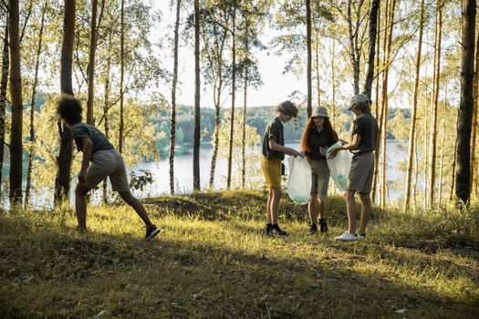 Boys and Girls Collecting Rubbish in Forest