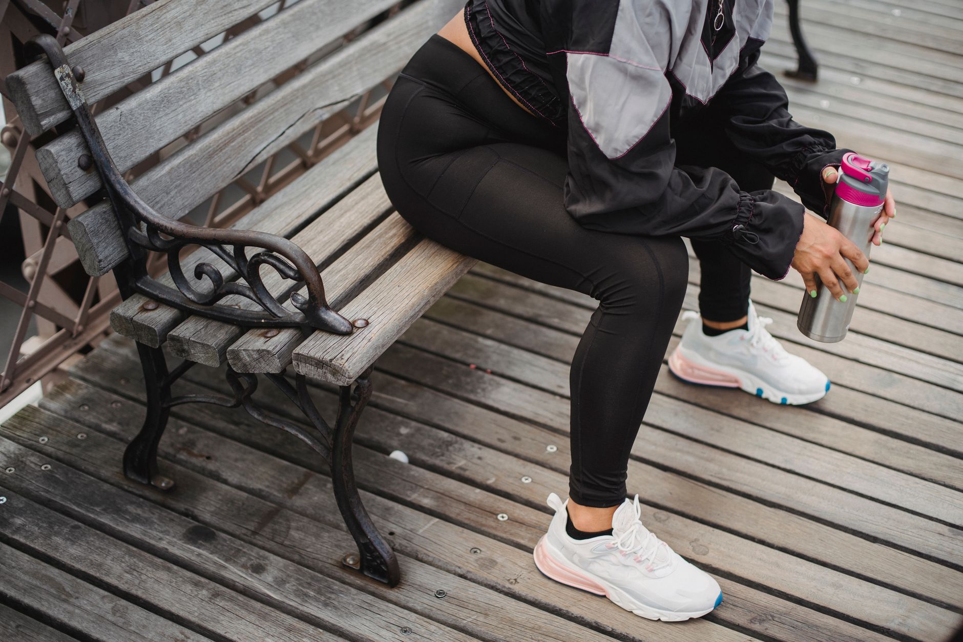 A woman resting with a water bottle after exercise, echoing the recovery promises now attached to creatine in midlife wellness.