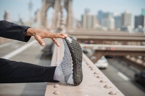 A Person Stretching on a Bridge