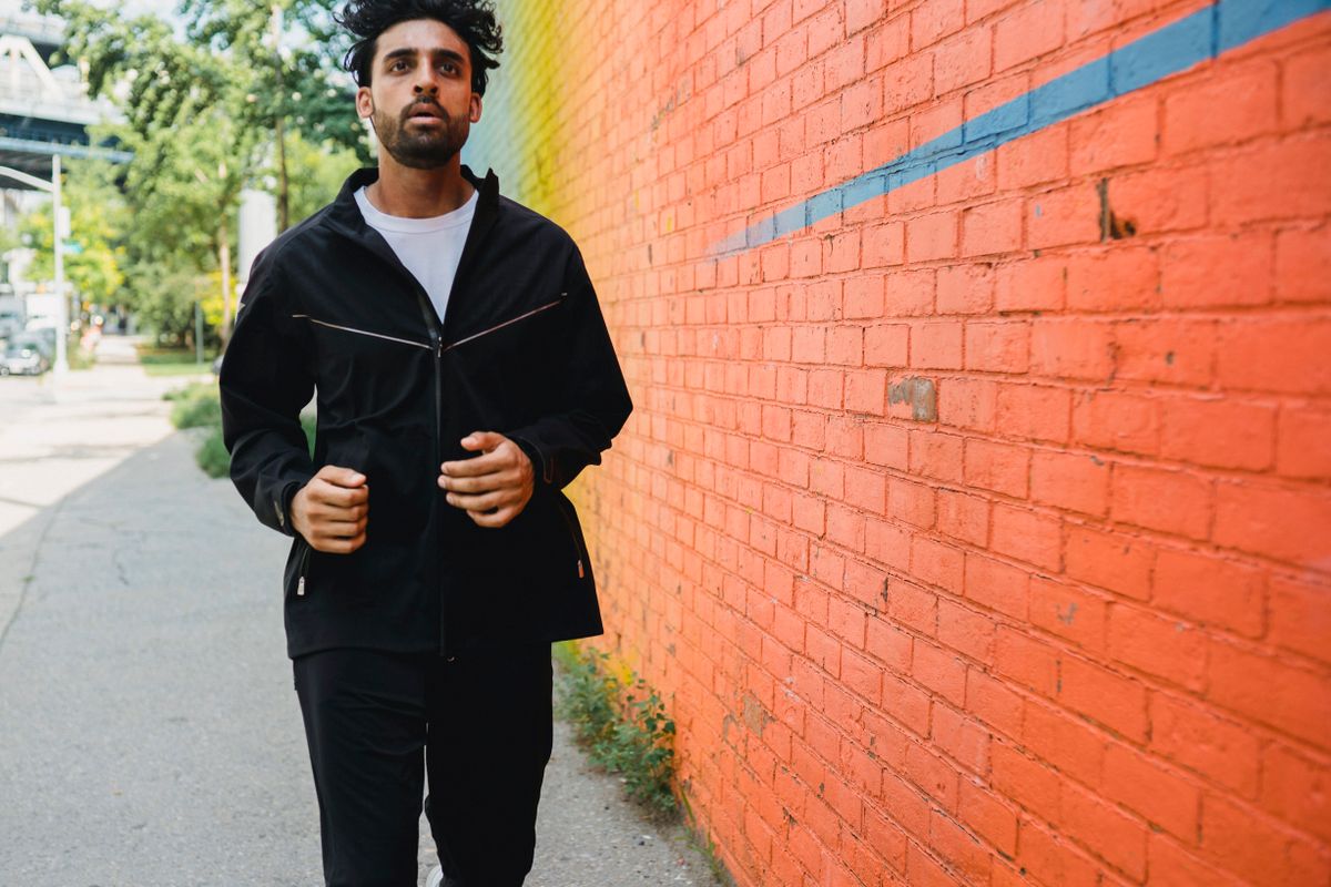 Man jogging through a city neighborhood