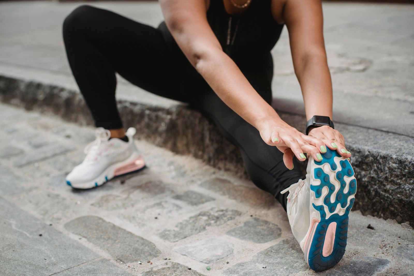 Runner stretching outdoors before a training session, demonstrating yoga for runners recovery routine