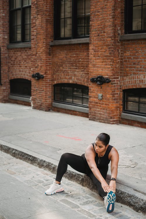 Free A Woman Stretching in a City Stock Photo