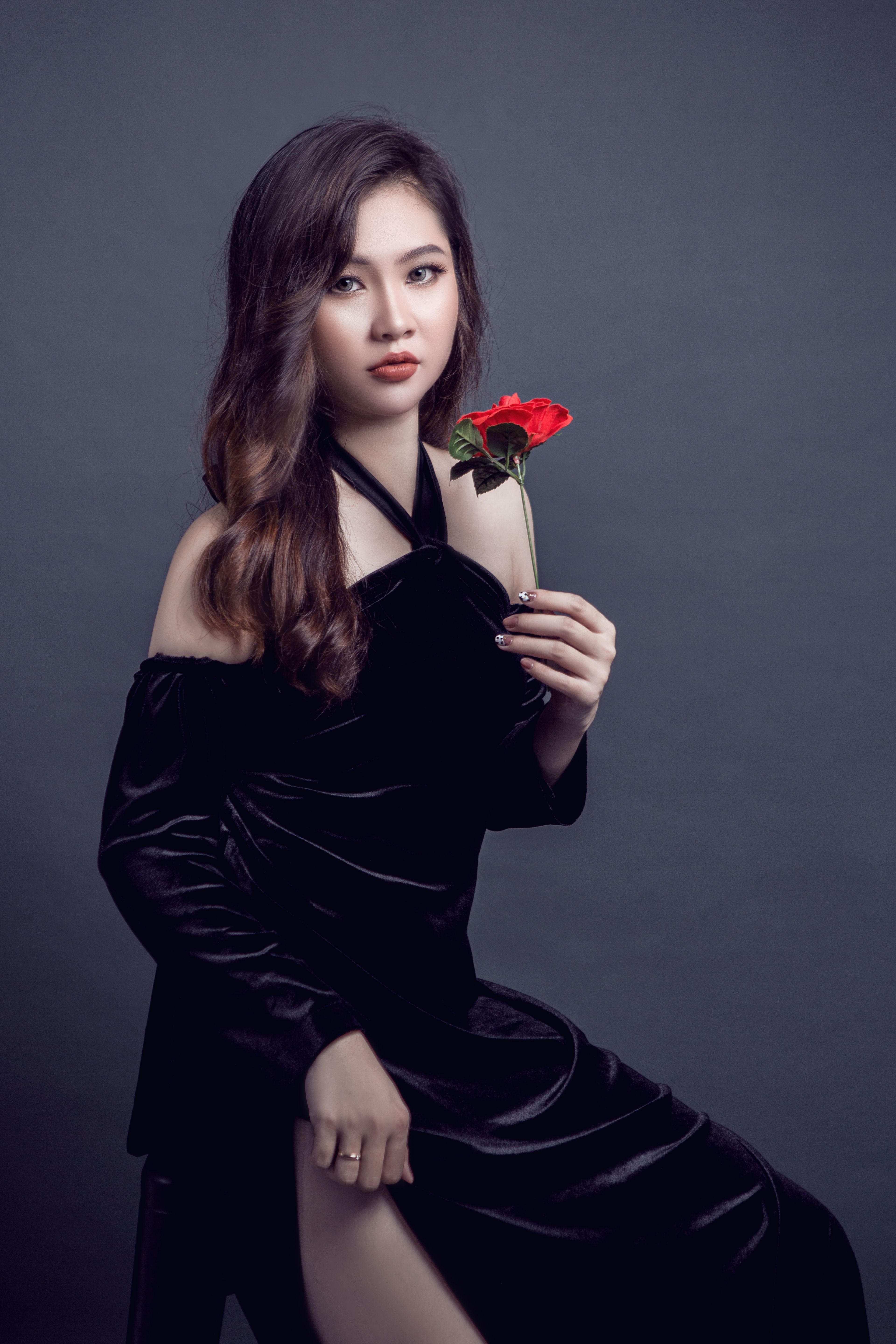 Woman in a black velvet off-the-shoulder dress