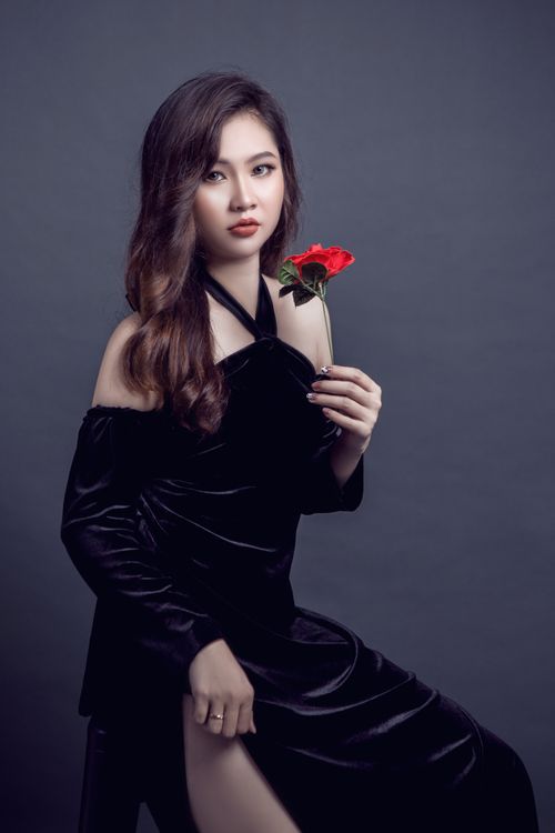 Woman in a black velvet off-the-shoulder dress