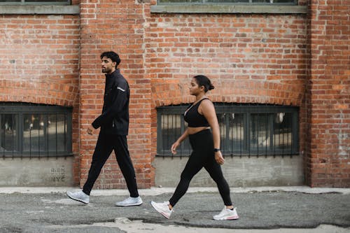 Photo of a Man and a Woman Wearing Sports Clothing
