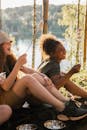 2 Women Sitting on Swing