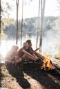 Happy Children Making Campfire in Forest