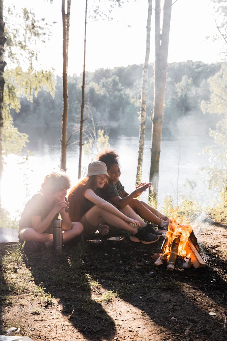 Happy Children Making Campfire In Forest