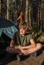 Woman in Green Shirt Sitting on Blue Tent