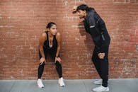 Man in Black Suit Jacket and Woman in Black Tank Top