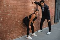 Woman in Black Tank Top and Black Pants Doing Yoga