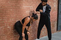 Woman in Black Tank Top and Pants Doing Push Up