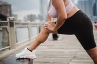 Woman in White Sports Bra and Black Leggings Wearing White Nike Sneakers